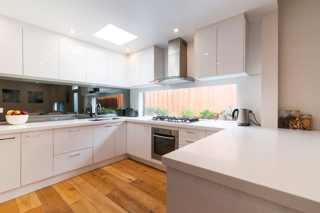 Designer kitchen with huge bench and stools for socialising.