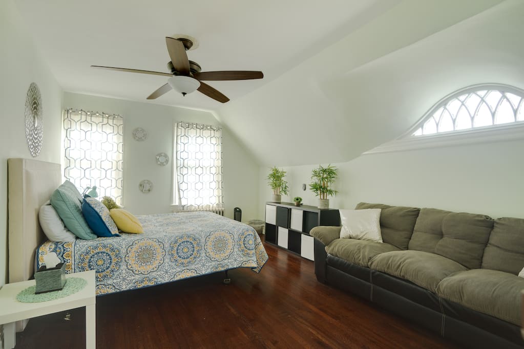 This is one of two large bedrooms featuring a queen size bed. The room also features a closet, luggage rack, couch and dresser. There is a portable heater, ceiling fan and extra towels and sheets available in the room as well.