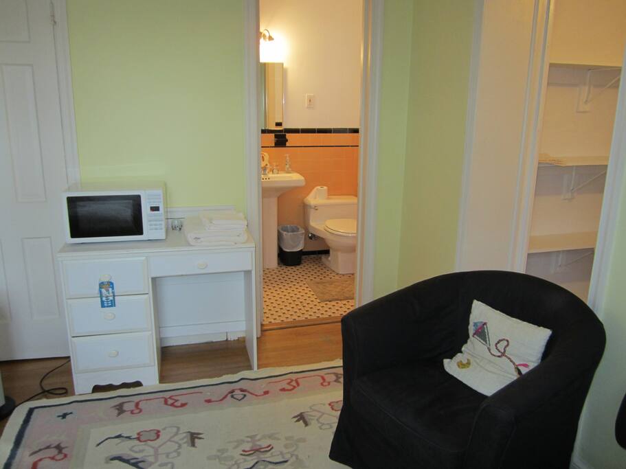 Private bathroom with bathtub and microwave in the room
