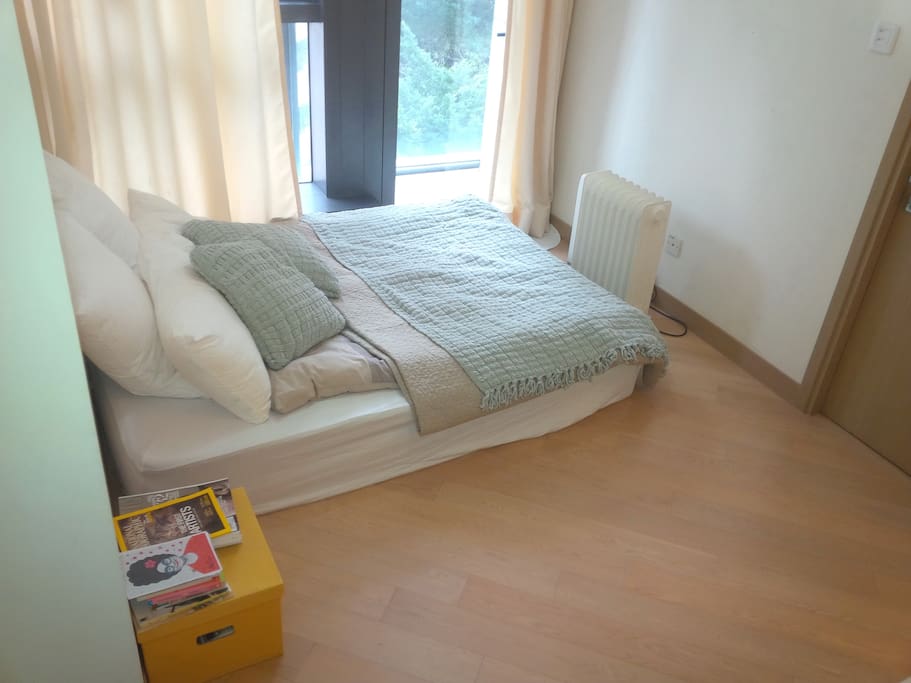 Queen-sized bed. Floor-to-ceiling window.