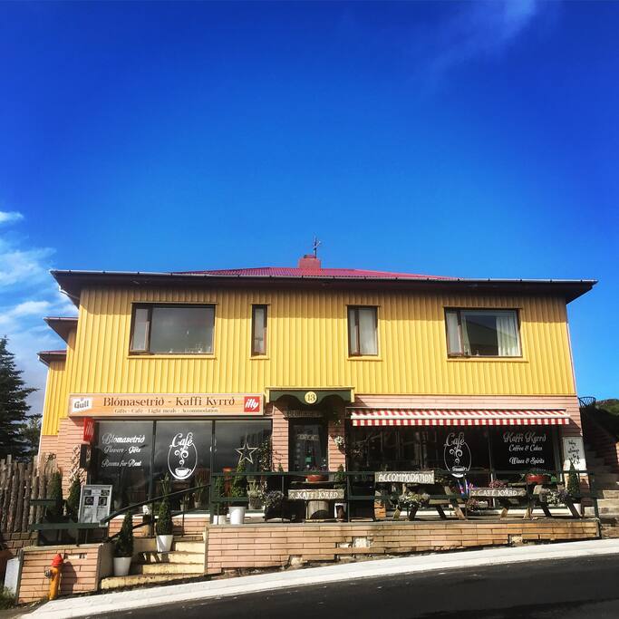 The front of the house and the entrance to the café on the ground floor where you check in
