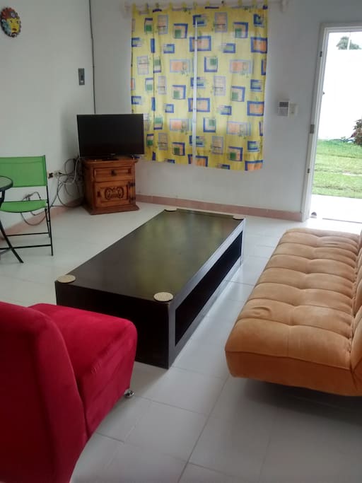 Living room area with Front Door View. Cable & WiFi. Futon can be used to sleep.