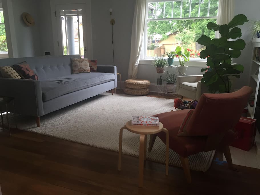 Large, comfortable sofa and rug in main floor living room.