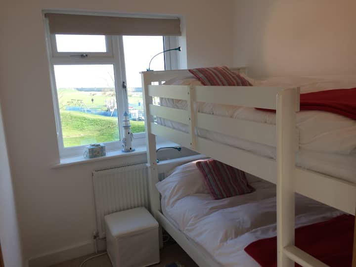 Adult size bunkbed overlooking the adventure playground and sea.