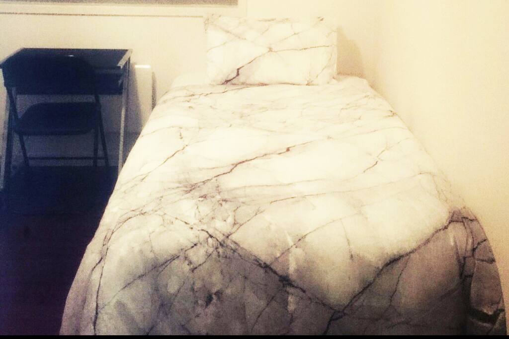 Comfortable King Single size bed with floor to ceiling wardrobe inclusive of drawers located on second level
