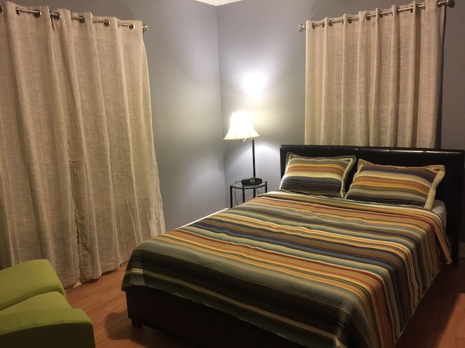Main Bedroom has a queen size bed, closet, small love seat.