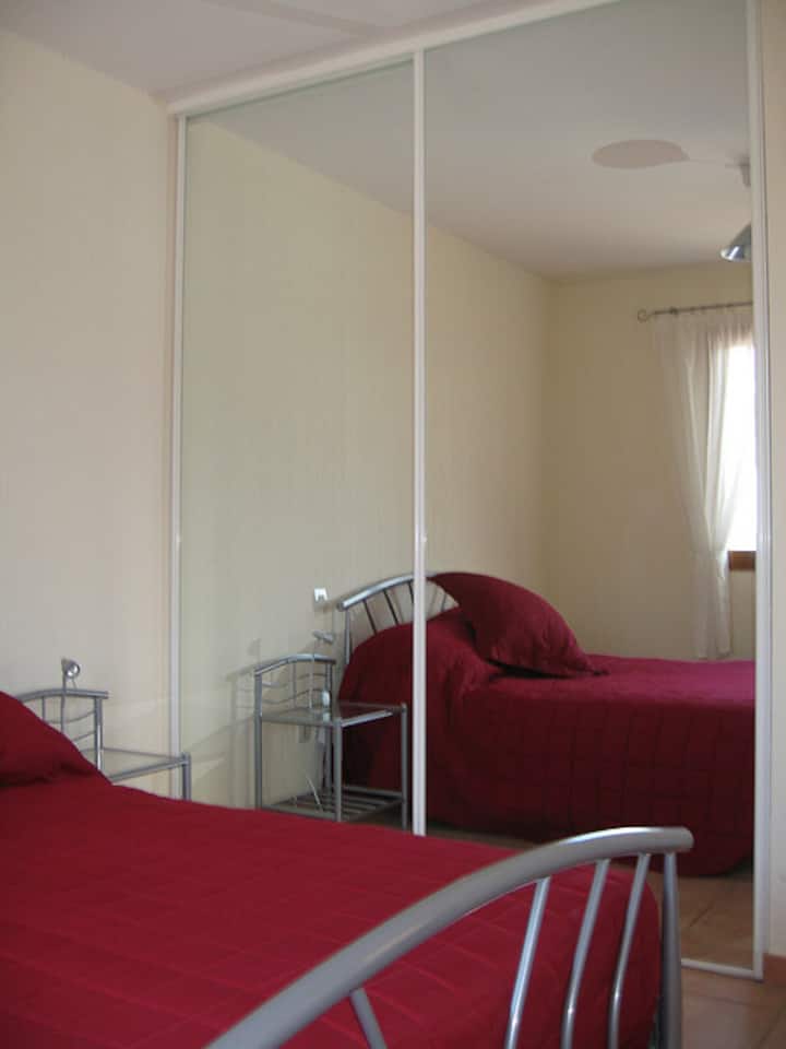 The primary bedroom with a double bed and ample closet space to unpack