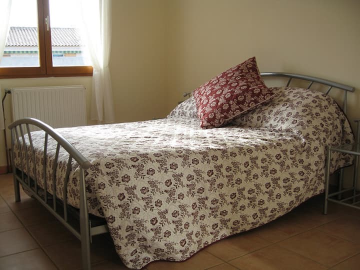Bedroom two with a comfortable double bed and soft, warm linen