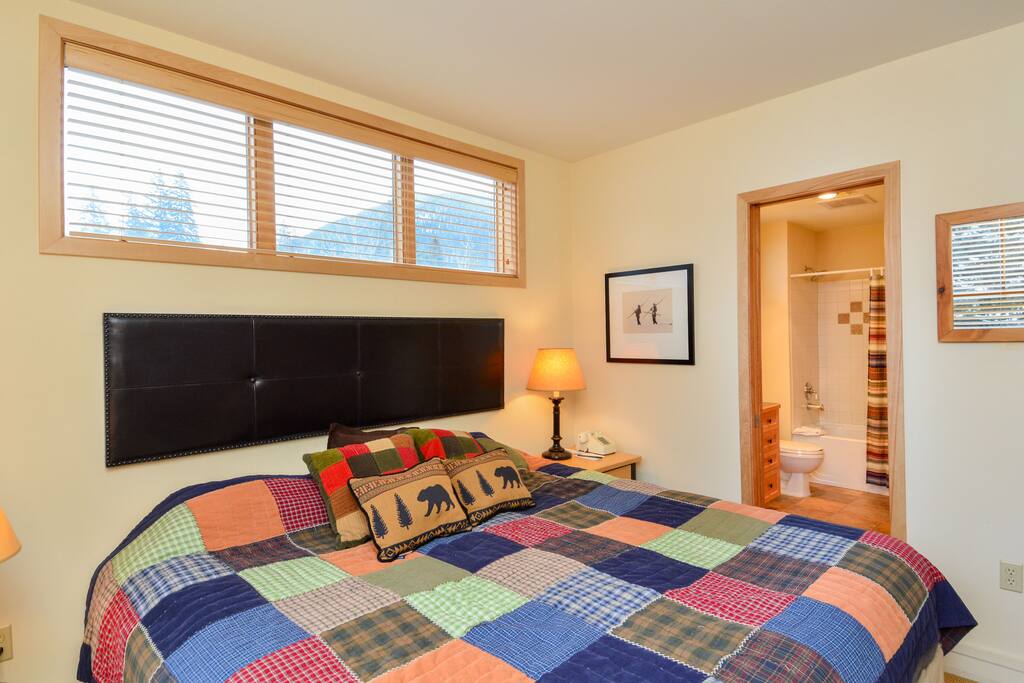 Bedroom with king size bed and bathroom entrance