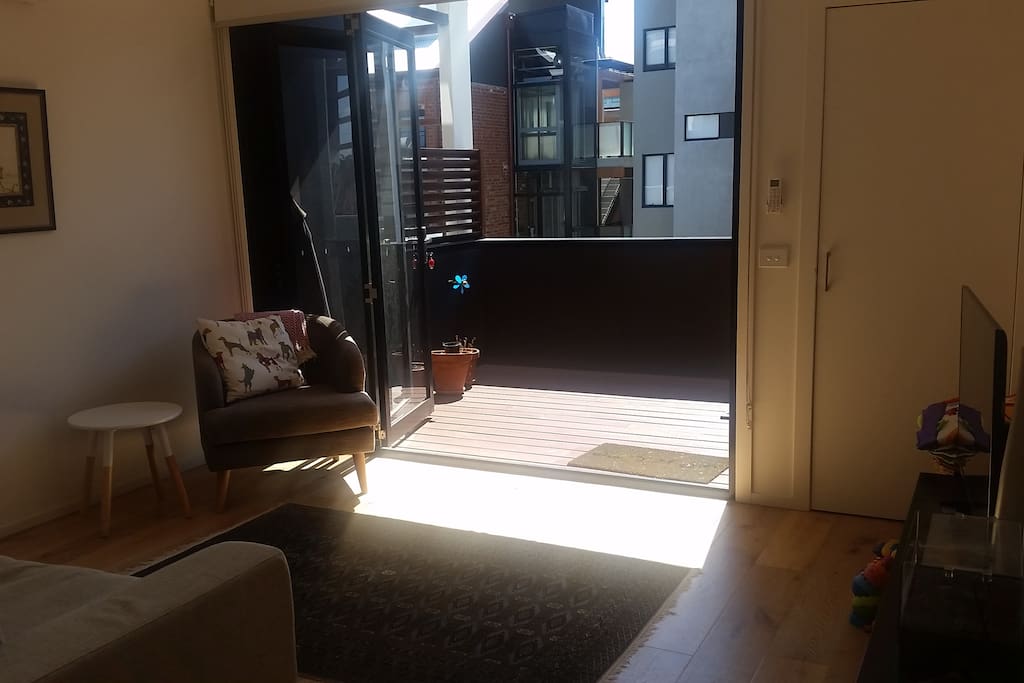 lounge opening onto a sun drenched deck