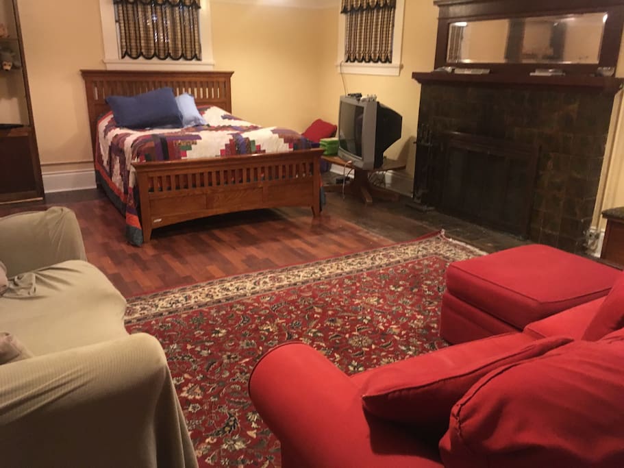 The large one room apartment has a queen bed, double futon