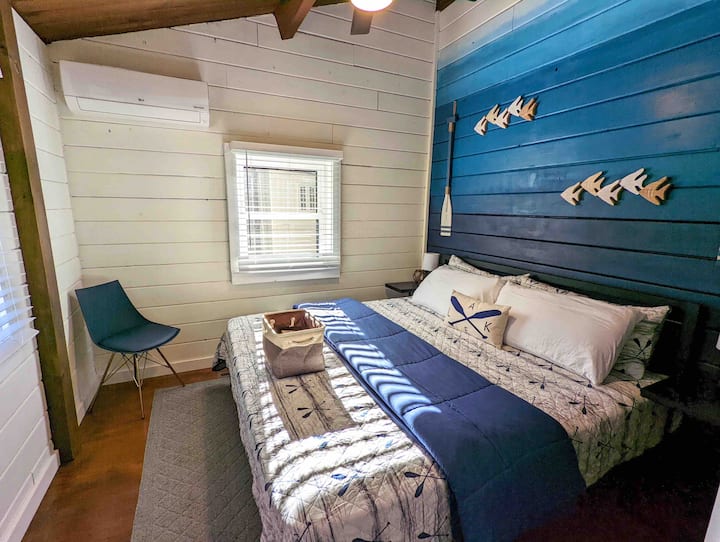 Bedroom 1 - “The Lake Room” with king bed, closet, dresser, and minisplit unit. Ombré under the water wall hand painted by owner!  Bedrooms located next to each other at back of house.