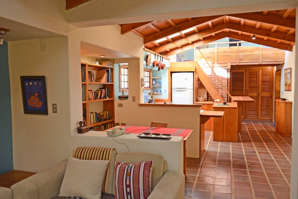 Looking from the living room, open concept, stairs lead up to the bed area