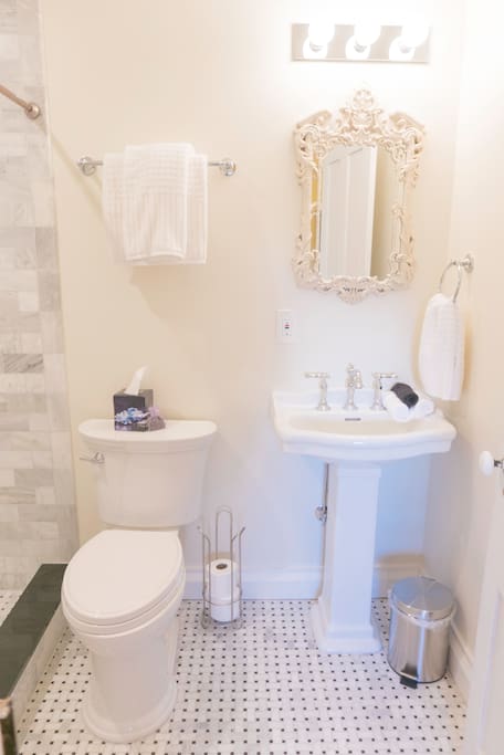 Private bathroom with beautiful lighting and radiant heat floors for your ultimate comfort. Unwind after a fun day in a large shower with two shower heads.