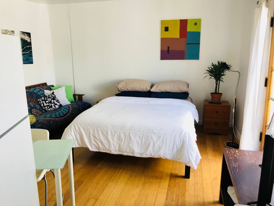 Comfortable queen bed in a bright, open concept studio space with privacy, serenity and relaxed zen found in the hills
