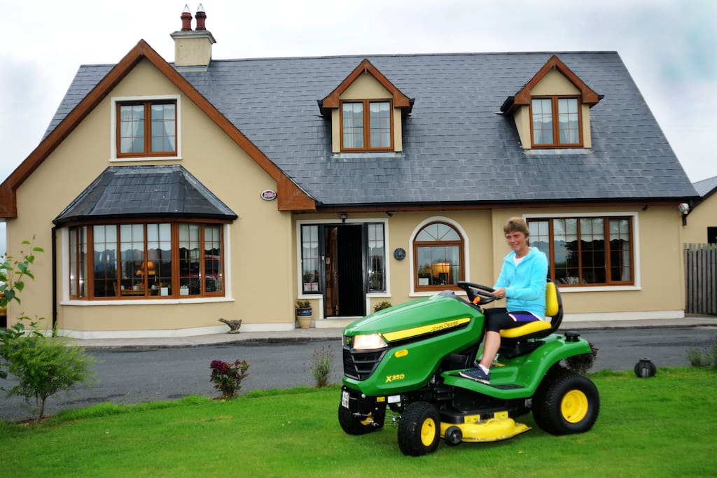 Eileen mowing the lawn and keeping the maincured lawns in tip top condition.