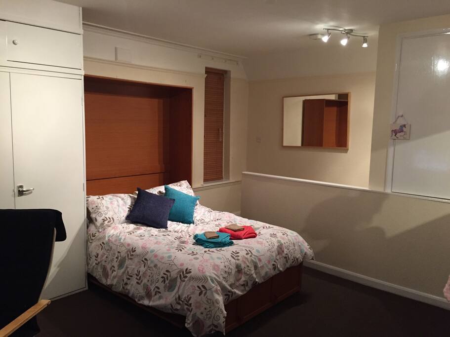 The bed pushes back into the wall to save on space.