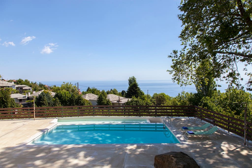The pool area in front of the villa with the amazing view to the total blue of Aegean Sea!