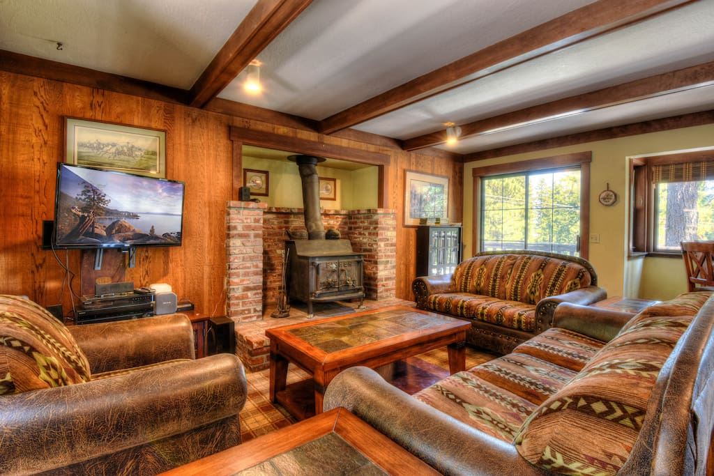 Comfortable living room with a wood burning fireplace and flat screen TV