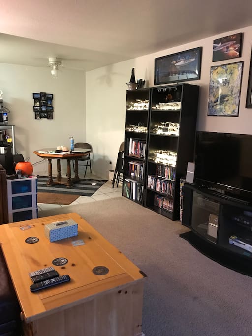 Dining area in background and entertainment center in foreground. I have a bit of a movie collection that I’m happy for you to utilize!