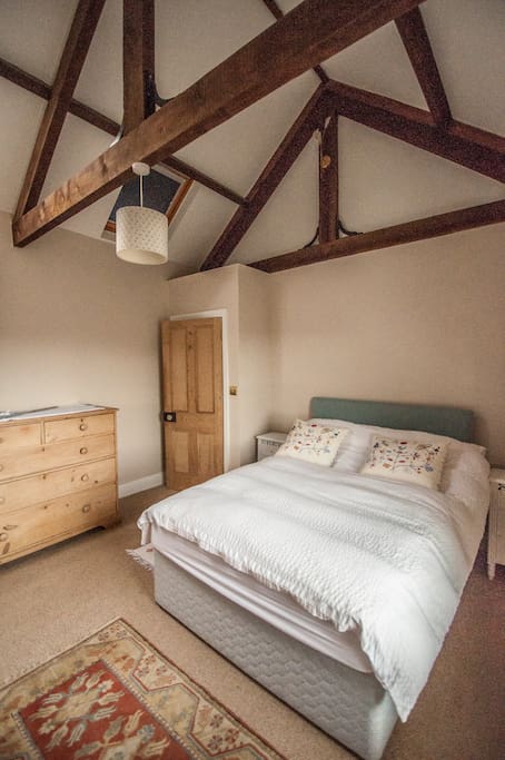Charming features in the room, old fireplace and exposed roof space.