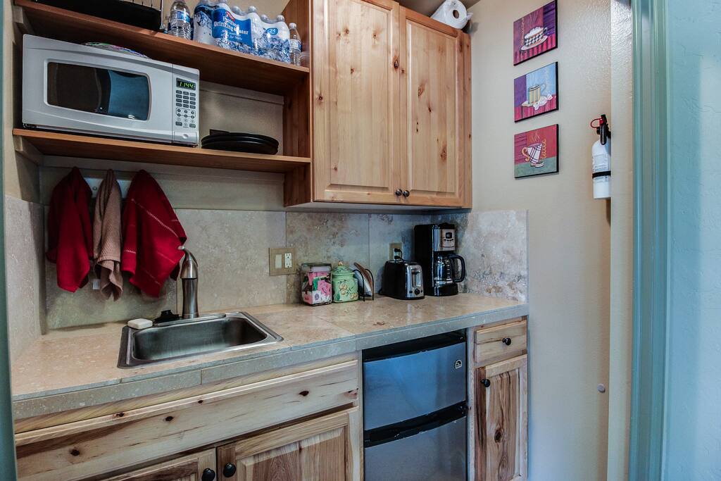 Kitchenette for guests use, coffeemaker, microwave, toaster, rice cooker, crock pot, induction cook top, silverware, cutting board, etc. Shared area with fridge and freezer.