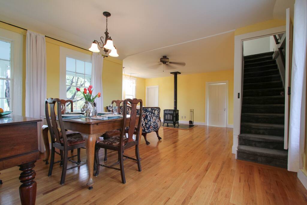 Long view from kitchen to dining room and living room. Stair case to upstairs. R.