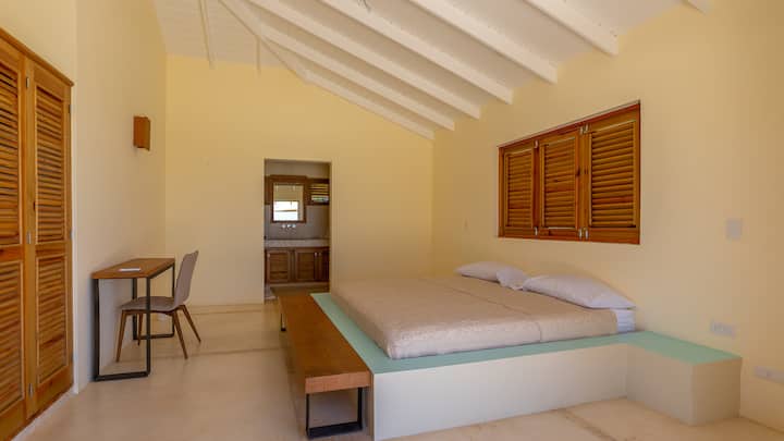 Bungalow next to villa: RIGHT bedroom with king bed, ac, bathroom with sink, toilet and shower.
