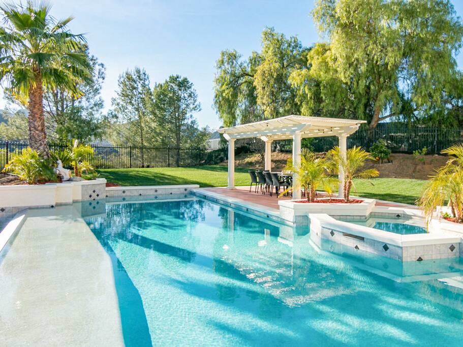 Dine al fresco at the 10-person patio table under the pergola.