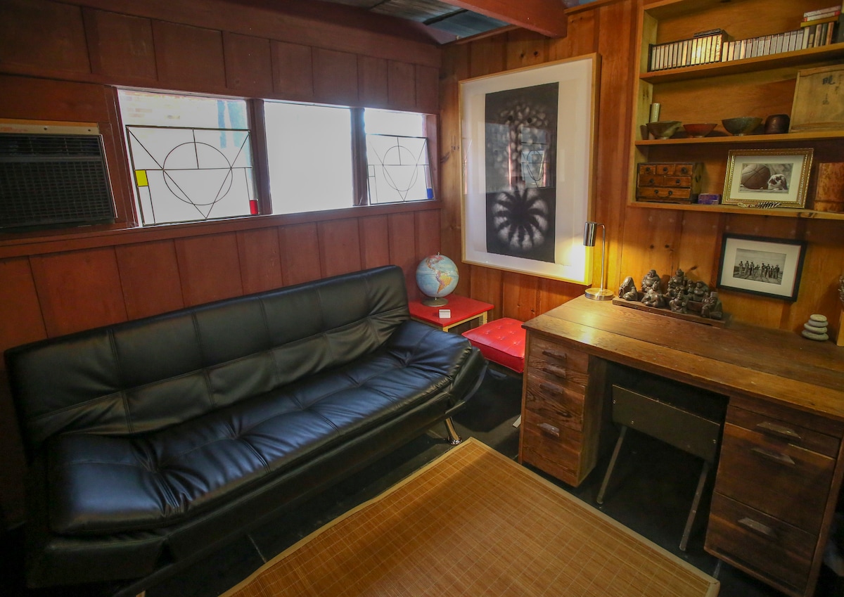 Second bedroom, with new sleeper sofa, desk, ac and heated black slate floors. 