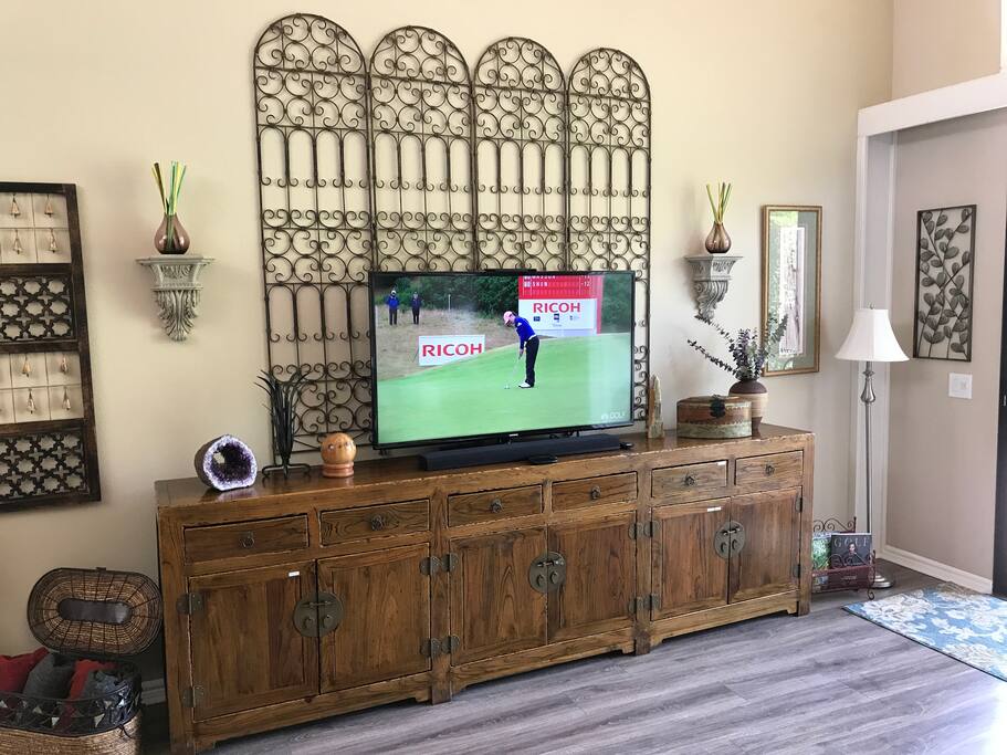 Living room TV on cool cabinet with DVD Player, Wii game console + board games