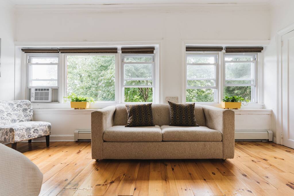 The back bedroom features plenty of natural light, a queen-sized bed, a spacious closet with another single-bed stored inside...