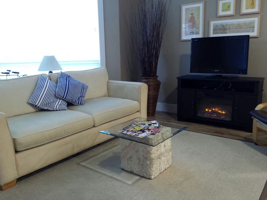 Open concept livingroom with cozy fireplace.
