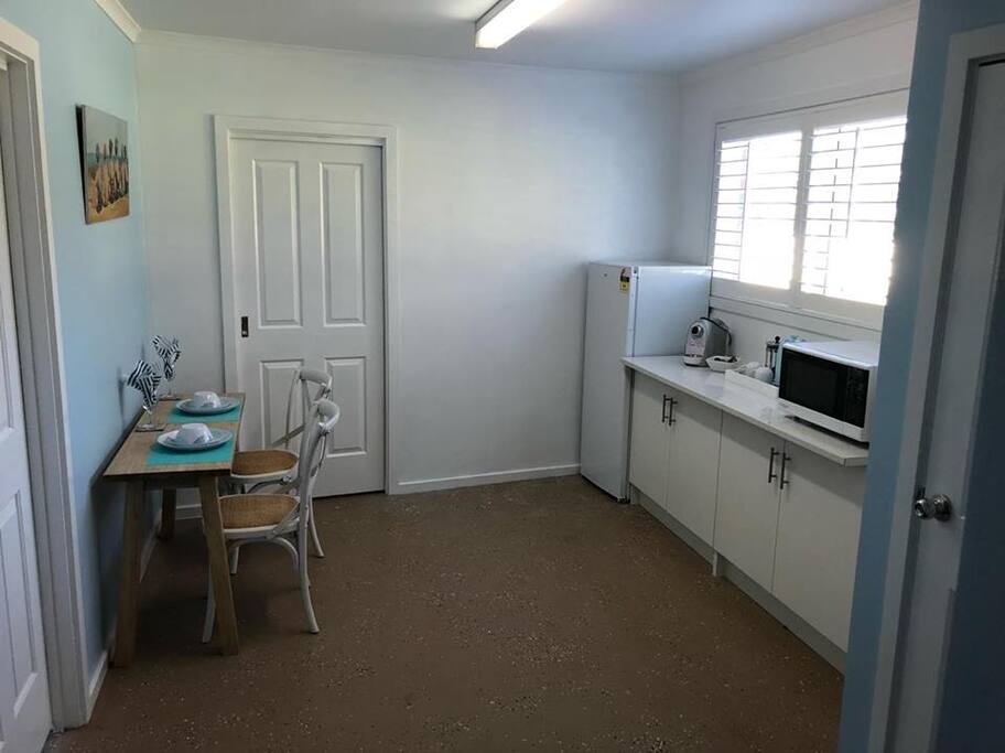 Kitchenette with coffee machine, fridge, freezer and microwave