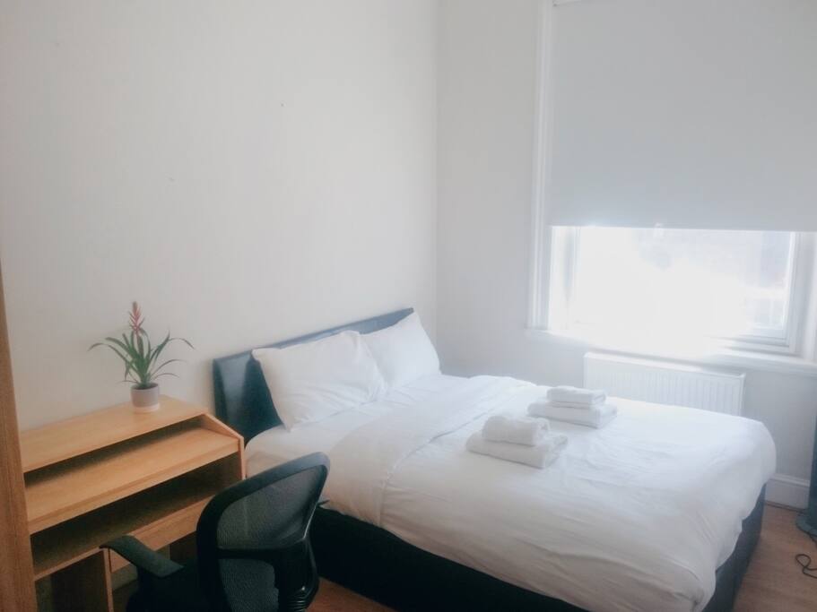 The main bedroom has a double bed and a wardrobe.