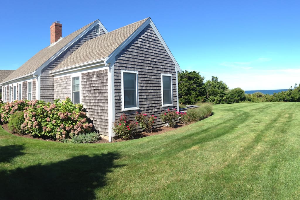 Grassy side yard with views of the water