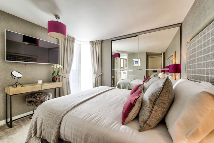 Master bedroom with wall mounted TV and en-suite shower room