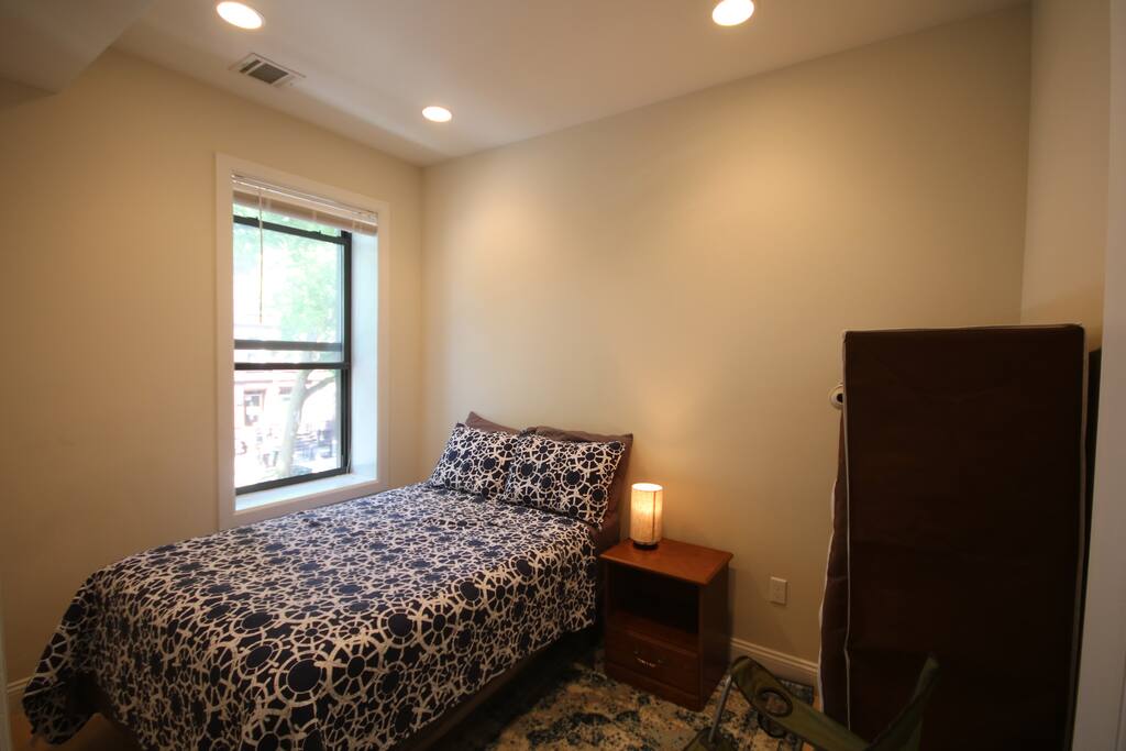 Ultra-comfortable mattress and plush pillows with tree canopy view from the window