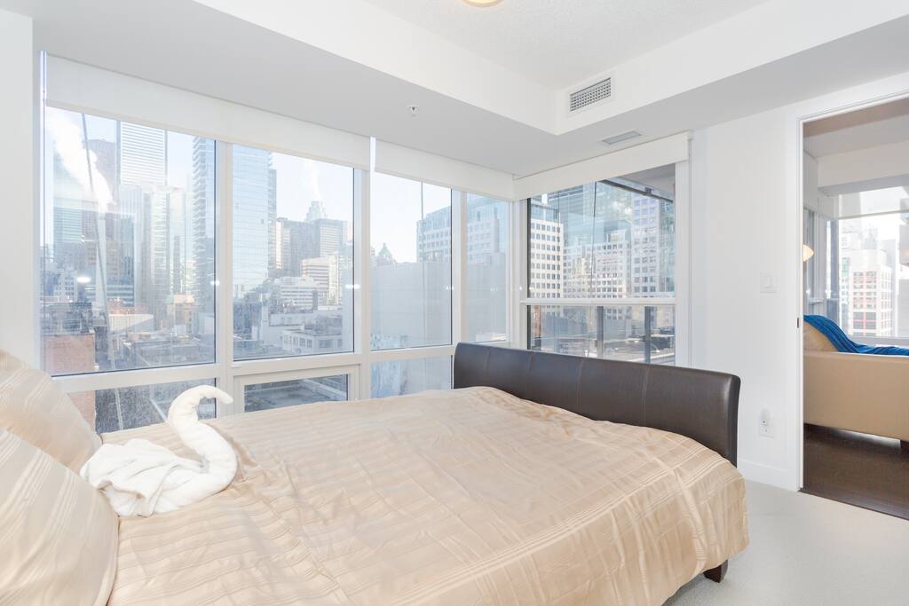 Master bedroom overlooking the beautiful building of downtown Toronto.