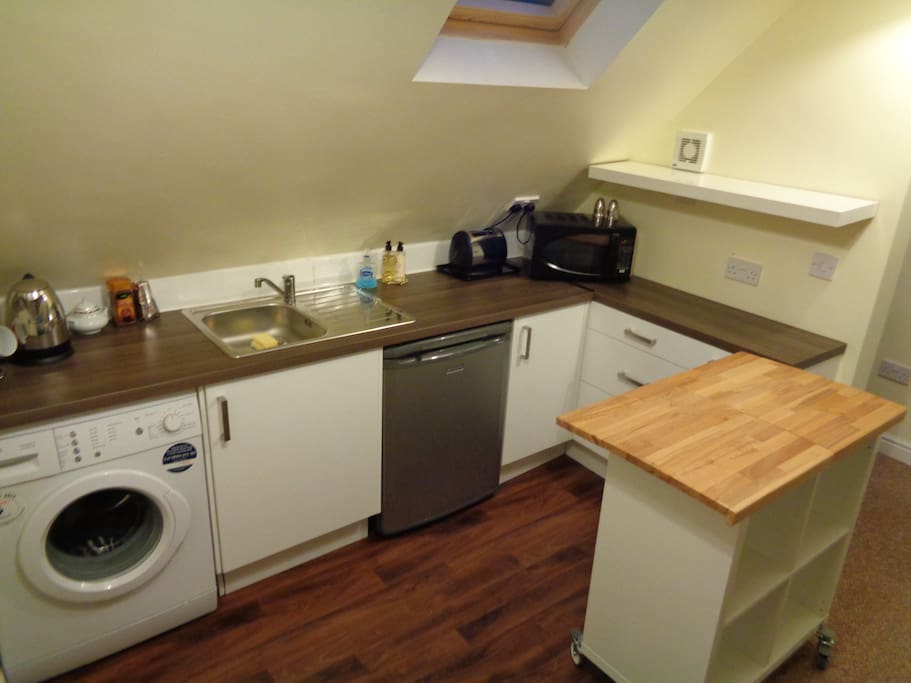 Kitchen with
Sink, Fridge, Microwave and washing machine