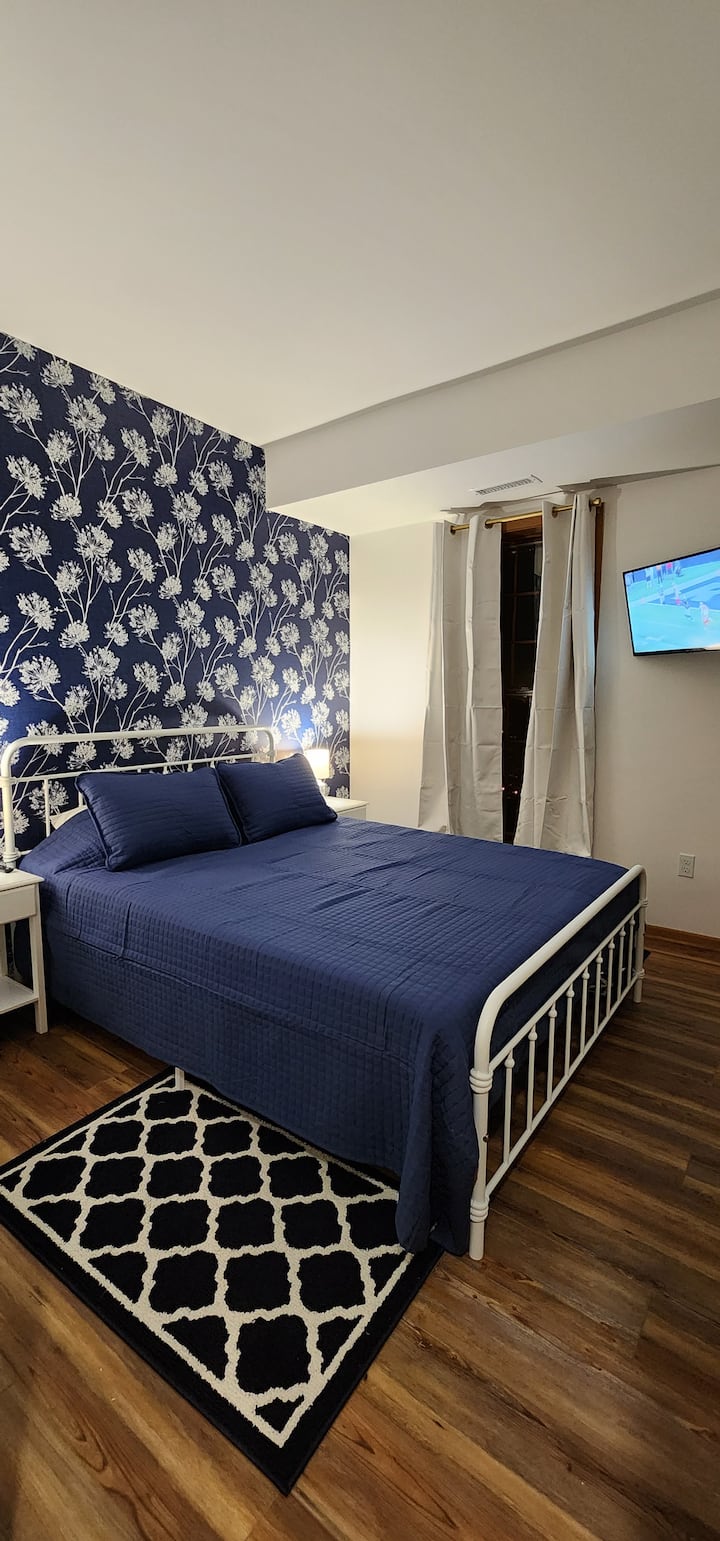 Queen bed with smart tv in bedroom 1