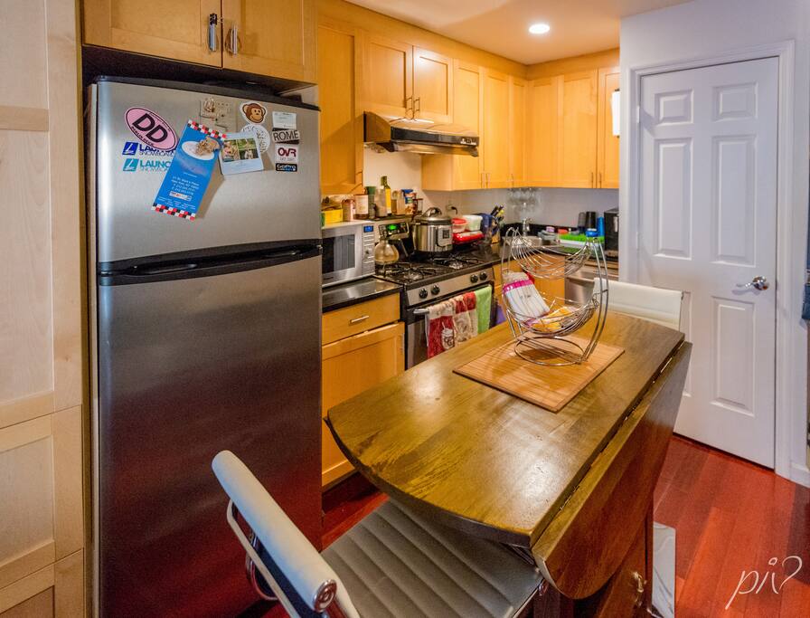 kitchen with washer and drier (on the right). brand new super quiet dish washer and all new appliances. table is brand new create and barrel solid wood.