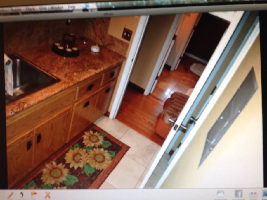 A different view from the kitchen to the hallway across it is the bathroom