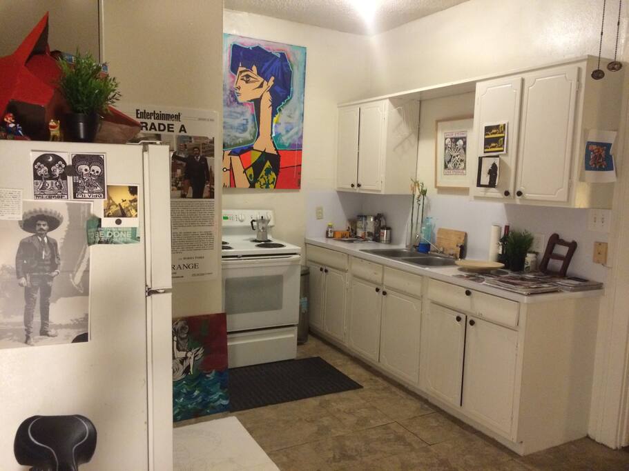 Roomy kitchen with cooking ware.