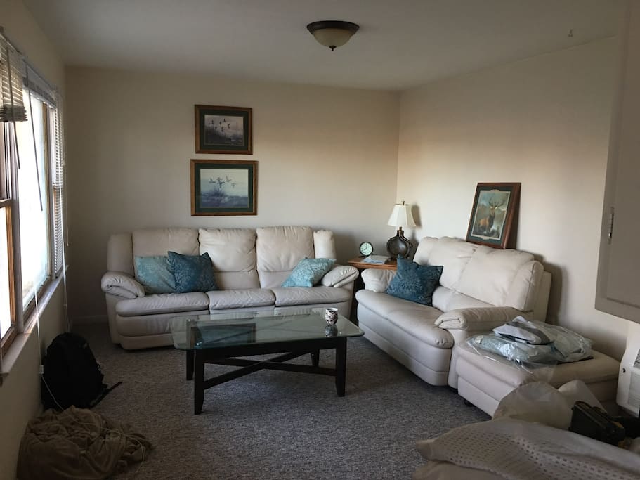 Living room area. Recliner couch. Tv has a DVD player and there is also 100 plus movies to pick from if interested. 32 inch flat screen tv.