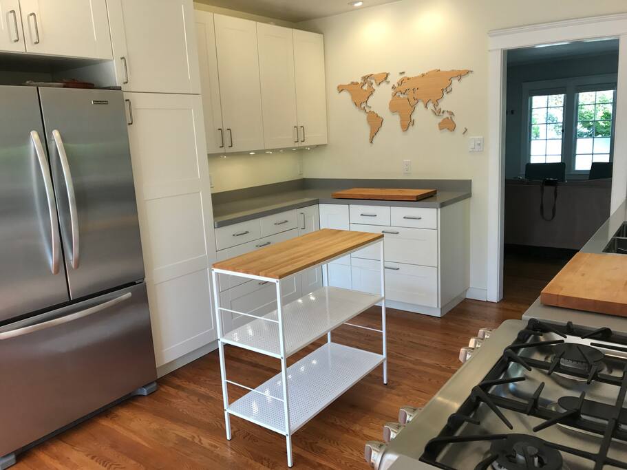 The other side of the kitchen, with even more counter space, a small island and a laser-cut wooden world map I made.