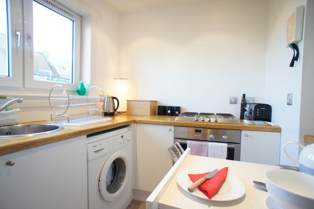 The kitchen is bright and well equipped with fridge/freezer, oven & gas hob, washing machine, microwave, kettle, toaster and cooking utensils which overlooks the beautifully kept communal rear garden