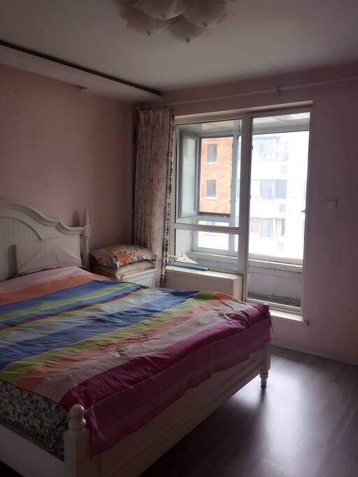 This is a master bedroom with a balcony,all of the bed sheets are clean and there is a big closet for our guests.