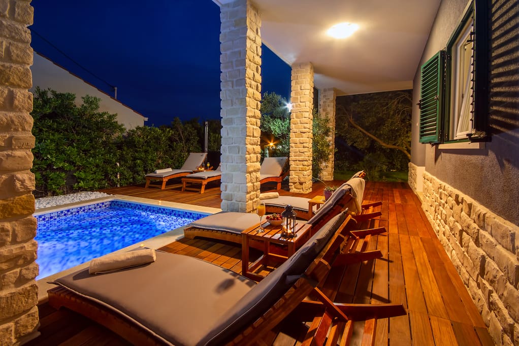 Beautiful night atmosphere with heated pool and nice decking furniture
