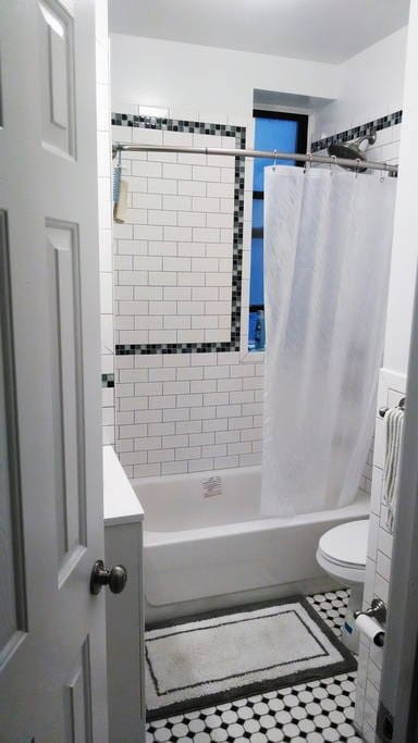 Bathroom with a shower and tub